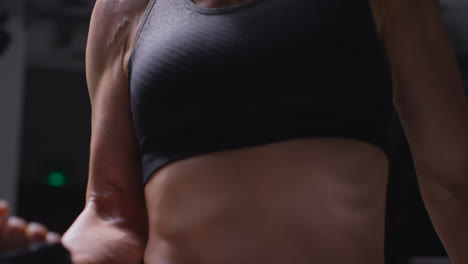 Close-Up-Studio-Shot-Of-Mature-Woman-Wearing-Gym-Fitness-Clothing-Exercising-With-Resistance-Band-2